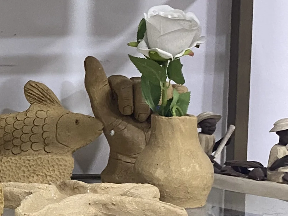 A handmade flower vase on the shelf at Alali