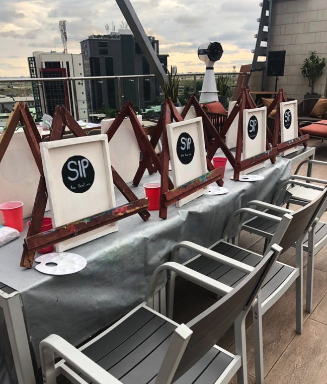 Easels, palettes and canvases set up for a KidzPaint session on the Turaka rooftop.